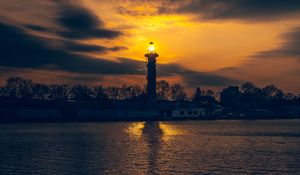 Preview wallpaper lighthouse, tower, light, water, trees, twilight, dark