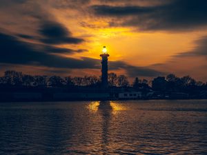Preview wallpaper lighthouse, tower, light, water, trees, twilight, dark