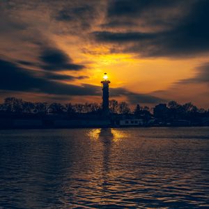 Preview wallpaper lighthouse, tower, light, water, trees, twilight, dark