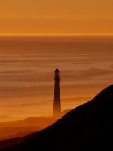 Preview wallpaper lighthouse, tower, sea, mountains, sunset, dark