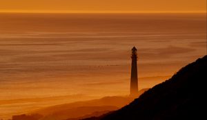 Preview wallpaper lighthouse, tower, sea, mountains, sunset, dark