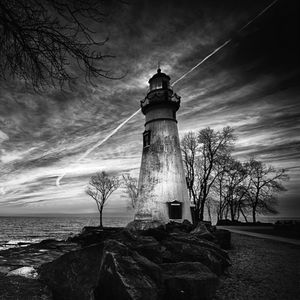 Preview wallpaper lighthouse, trees, coast, sea, bw