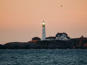 Preview wallpaper lighthouse, water, horizon, glare, building