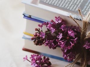 Preview wallpaper lilac, flowers, books, reading, aesthetics