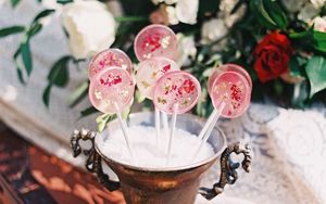 Preview wallpaper lollipops, candy, pink, flowers, cup