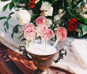 Preview wallpaper lollipops, candy, pink, flowers, cup