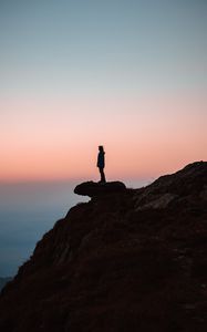 Preview wallpaper loneliness, alone, rock, slope, sunset