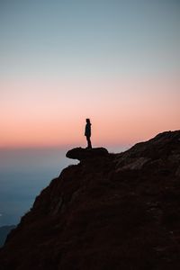 Preview wallpaper loneliness, alone, rock, slope, sunset