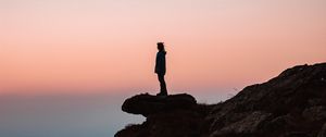 Preview wallpaper loneliness, alone, rock, slope, sunset