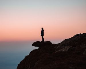 Preview wallpaper loneliness, alone, rock, slope, sunset