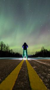 Preview wallpaper man, alone, backlight, road, northern lights