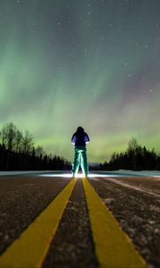 Preview wallpaper man, alone, backlight, road, northern lights