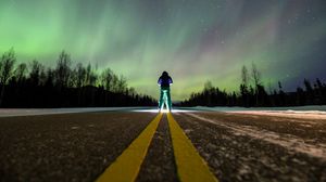 Preview wallpaper man, alone, backlight, road, northern lights