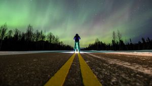 Preview wallpaper man, alone, backlight, road, northern lights