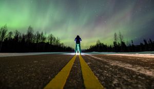 Preview wallpaper man, alone, backlight, road, northern lights