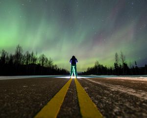 Preview wallpaper man, alone, backlight, road, northern lights