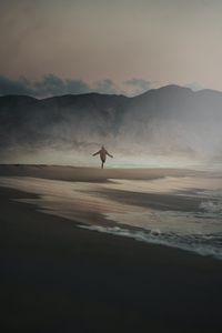 Preview wallpaper man, alone, beach, rocks, fog