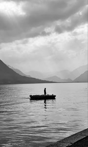 Preview wallpaper man, alone, boat, lake, black and white