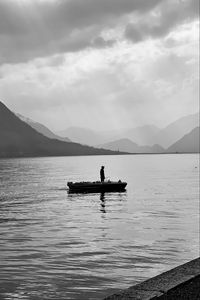 Preview wallpaper man, alone, boat, lake, black and white