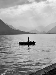 Preview wallpaper man, alone, boat, lake, black and white