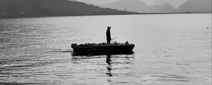 Preview wallpaper man, alone, boat, lake, black and white