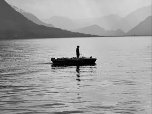 Preview wallpaper man, alone, boat, lake, black and white