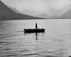 Preview wallpaper man, alone, boat, lake, black and white