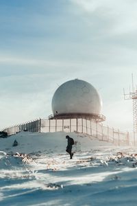 Preview wallpaper man, alone, building, ball, snow, winter, white