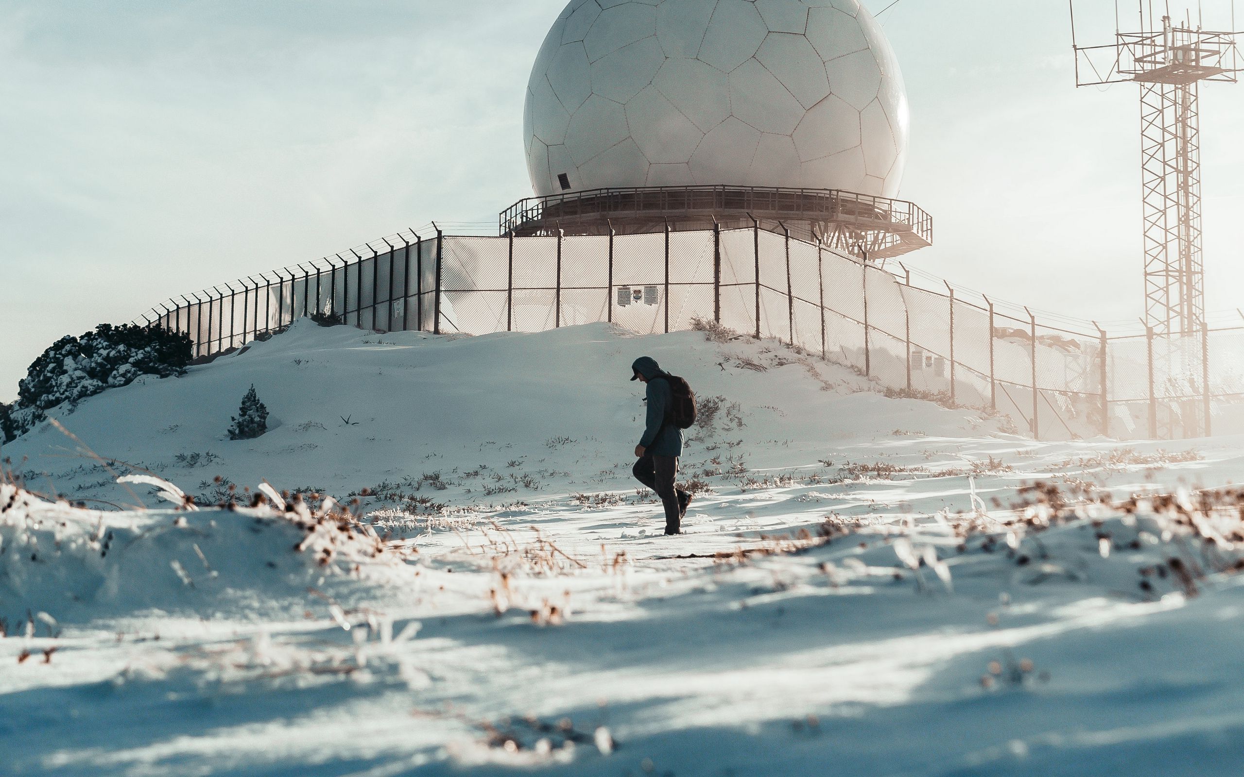 2560x1600 Wallpaper man, alone, building, ball, snow, winter, white