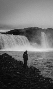 Preview wallpaper man, alone, bw, waterfall, nature