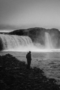 Preview wallpaper man, alone, bw, waterfall, nature