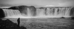 Preview wallpaper man, alone, bw, waterfall, nature