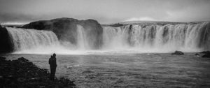 Preview wallpaper man, alone, bw, waterfall, nature