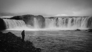 Preview wallpaper man, alone, bw, waterfall, nature