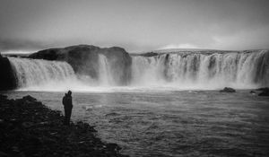 Preview wallpaper man, alone, bw, waterfall, nature