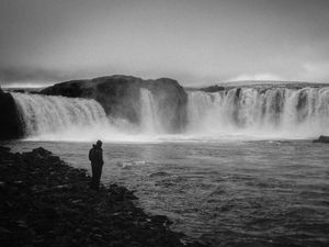 Preview wallpaper man, alone, bw, waterfall, nature