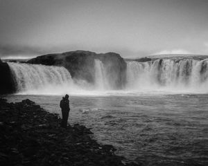 Preview wallpaper man, alone, bw, waterfall, nature