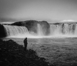 Preview wallpaper man, alone, bw, waterfall, nature