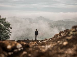 Preview wallpaper man, alone, cliff, mountains, fog