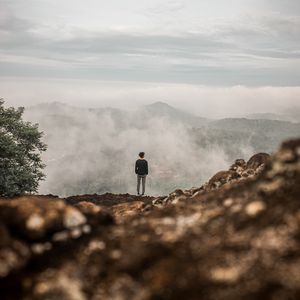 Preview wallpaper man, alone, cliff, mountains, fog