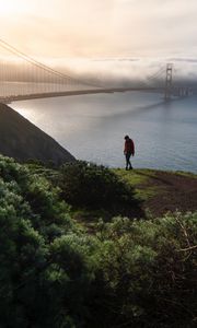 Preview wallpaper man, alone, hill, river, bridge, fog