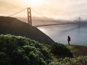 Preview wallpaper man, alone, hill, river, bridge, fog