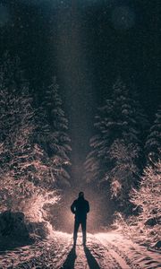 Preview wallpaper man, alone, light, snow, winter, forest, dark