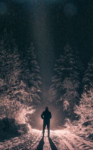 Preview wallpaper man, alone, light, snow, winter, forest, dark