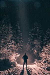 Preview wallpaper man, alone, light, snow, winter, forest, dark