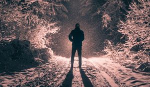 Preview wallpaper man, alone, light, snow, winter, forest, dark