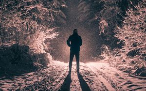 Preview wallpaper man, alone, light, snow, winter, forest, dark