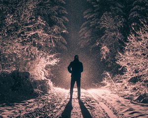 Preview wallpaper man, alone, light, snow, winter, forest, dark