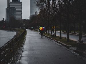 Preview wallpaper man, alone, rain, umbrella, embankment, city