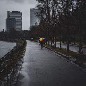 Preview wallpaper man, alone, rain, umbrella, embankment, city